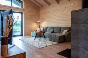 a living room with a couch and a table at Zrub Lipa, Tatry, krb a súkromie in Mengusovce +15 photos
