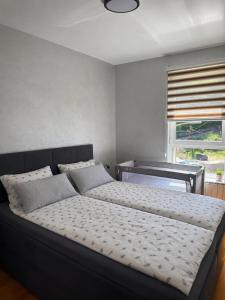 a bed in a bedroom with a piano at CENTRAL POINT APARTMENT - City centar Zenica- in Zenica +36 photos