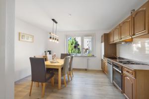 a kitchen with a wooden table and a dining room at Fewo Diemelrauschen in Eimelrod