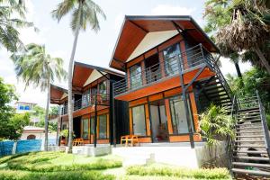 a house with a staircase leading up to it at Rhythm Beach in Trincomalee