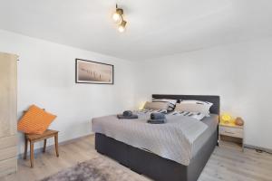 a bedroom with a bed and a table and a chair at Fewo Diemelrauschen in Eimelrod