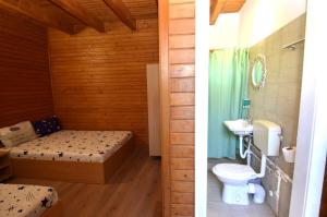 a bathroom with a bed and a toilet and a sink at Vila Flora Costinesti in Costinesti +84 photos