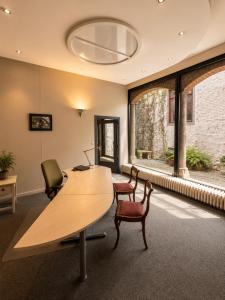 an office with a desk and chairs and a large window at Villa Theresa à 25 min de PAIRI DAIZA in Soignies
