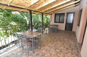 a patio with tables and chairs on a balcony at Vila Flora Costinesti in Costinesti