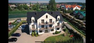 an aerial view of a large white house at Willa Relaksowa in Karwia