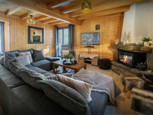 a living room with a couch and a fireplace at Chalet Igel - OVO Network in Châtel