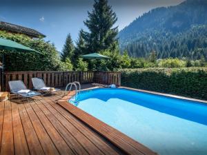 a swimming pool on a wooden deck next to at Chalet Igel - OVO Network in Châtel