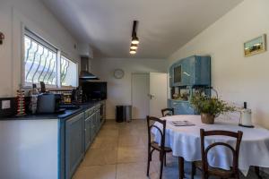 a kitchen with a table with a white table cloth at Gîte du mouta in Saint-Justin