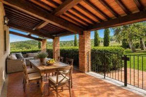 an outdoor patio with a wooden table and chairs at Borgo Iesolana Country Retreat in Bucine +121 photos