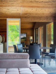 a living room with a couch and tables and chairs at WOO® Loft Resort in Fiesch