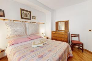 a bedroom with a bed and a dresser and a mirror at Terrazza Valtellina in Grosio