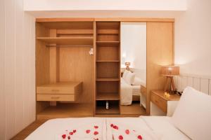 a bedroom with a bed and a desk and a closet at Santai Studios in Badung +19 photos