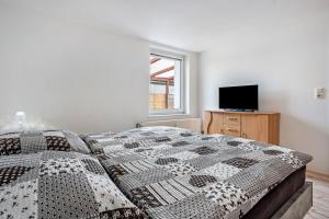 a bedroom with a large bed and a television at Ferienwohnung bis zu 6 Per. 65 M² in Wolgast