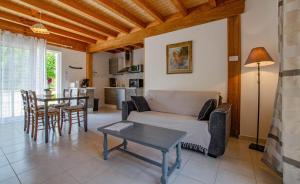 a living room with a couch and a table at Les prés saint jean in Champigny-sur-Aube