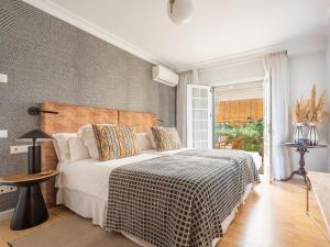 a bedroom with a bed and a large window at Hotel Boutique San Diego - Adults Only in Las Lagunas