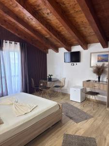 a bedroom with a bed and a table and chairs at Bella Vista in Shkodër