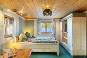 a bedroom with a bed and a wooden ceiling at Haus Elfriede Schmid in Bad Bayersoien