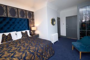 a bedroom with a large bed and a blue carpet at Bellinter House Hotel & Spa in Navan
