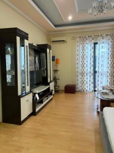 a large living room with a television and a couch at Villa Klinton in Durrës