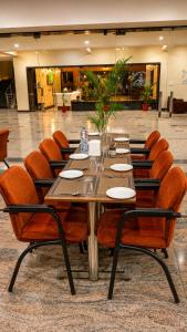 a long wooden table and chairs in a room at Khatu Bagh Resort in Sīkar
