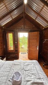 a large bed in a room with a large window at Kuna GlampCamp in Gitgit +25 photos