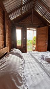 a large bedroom with two beds in a room at Kuna GlampCamp in Gitgit