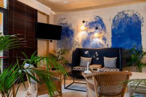 a living room with a couch and some plants at Hotel Anabel in Lloret de Mar