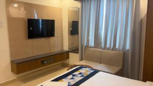 a hotel room with a bed and a television at The Kashi Dharohar in Varanasi +21 photos