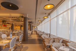a row of tables and chairs in a restaurant at Hotel Anabel in Lloret de Mar