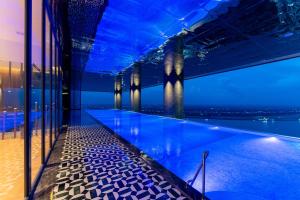a swimming pool in a building with blue lights at Steigenberger Phnom Penh in Phnom Penh