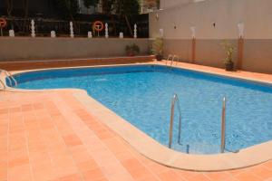 a large swimming pool in a building with a tile floor at Hotel Cassandra in El Arenal