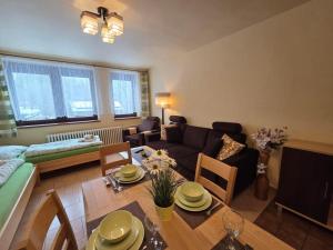 a living room with a couch and a dining table at U Macháčků - Lipno in Lipno nad Vltavou