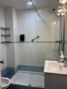 a bathroom with a shower and a tub and a sink at La Explanada in Alicante +44 photos