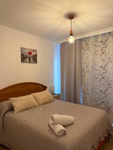 a bedroom with a bed with a hat on it at La Explanada in Alicante
