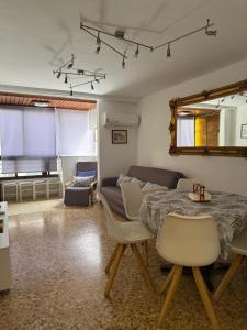 a living room with a table and a couch at La Explanada in Alicante