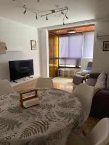 a living room with a table and a couch at La Explanada in Alicante