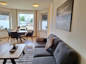 a living room with a couch and a table at Ferienwohnung Küstennah in Großenwiehe