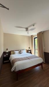 a bedroom with a large bed and a window at Gemstay Hotel Hue in Thôn Trường Giang
