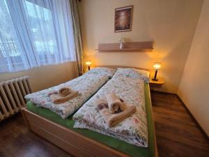 a bedroom with a bed with towels on it at U Macháčků - Lipno in Lipno nad Vltavou +44 photos
