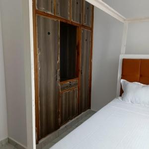 a small bedroom with a bed and a window at MahaliaLuxuryStays in Malindi