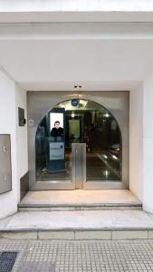 a door to a building with a man standing in it at Estudio Residencias in Buenos Aires