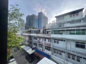a building in a city with tall buildings at MAXi MaMa Room in Bangkok