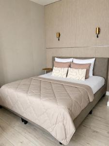 a bedroom with a large bed with white sheets and pillows at Maison Lumière - Private Rooftop terrace in Amsterdam