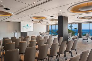 a conference room with chairs and a podium in a room with the ocean at Amathus Beach Hotel Limassol in Limassol +72 photos