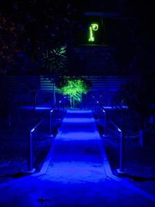 a walkway lit up in blue at night at Chimera Pia Aparts in Cıralı