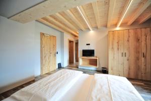 a bedroom with a large bed and wooden cabinets at Pension Garni Hochmoos in Lermoos