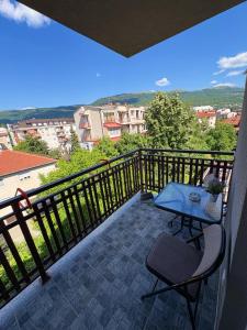 a patio with a table and chairs on a balcony at Luxury Apartment Poli in Ohrid
