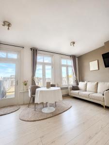 a living room with a table and a couch at Maison Lumière - Private Rooftop terrace in Amsterdam