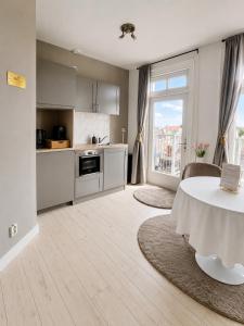 a kitchen with a table and a large window at Maison Lumière - Private Rooftop terrace in Amsterdam