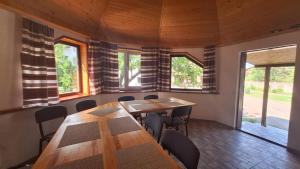 a dining room with tables and chairs and windows at Hollywood in Yaremche